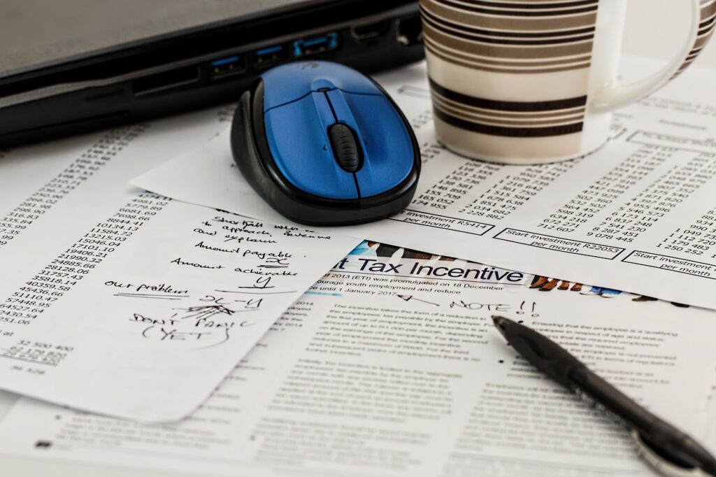 A calculator, pen, and pages showing itemized tax deductions and credits for homeowners