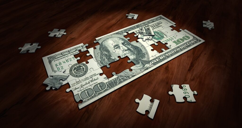 Jigsaw puzzle of hundred dollar bills with completed house outline, symbolizing the financial puzzle of homeownership and the importance of credit score